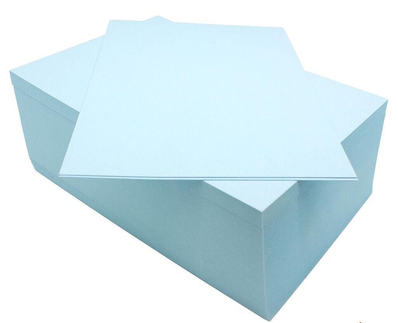 May include: A stack of light blue index cards. The cards are arranged in a rectangular shape and are ready for note-taking or crafting.