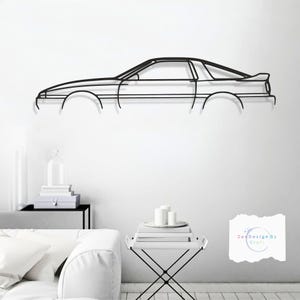 Puede incluir: Arte mural de metal negro que representa el perfil lateral de un coche deportivo clásico. La obra de arte presenta un diseño minimalista, mostrando la silueta del coche con líneas limpias y un alerón. Para los entusiastas del automóvil.