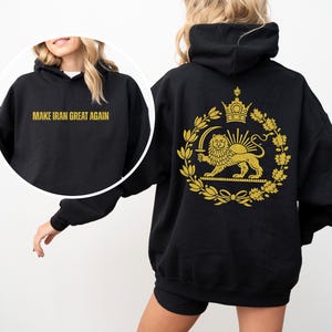 May include: Black hoodie with gold text "MAKE IRAN GREAT AGAIN" on the front. The back features a gold emblem with a lion, crown, and wreath design. A casual, comfortable sweatshirt.
