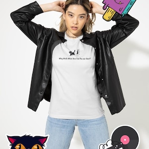 May include: A white t-shirt with a black cat and a white mouse graphic and the text "Why Walk When You Can Pas de Chat?"  The model is wearing a black leather jacket and blue jeans. There are also stickers of a black cat face, a cassette tape and a record, and a purple popsicle with a face.