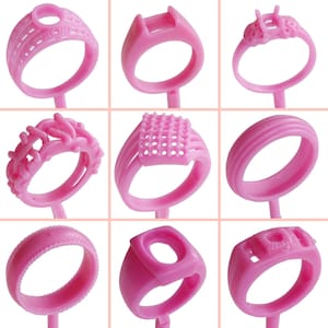 May include: Nine pink wax ring molds for jewelry making. The molds are made of a soft, flexible material and are designed to create a variety of ring styles.
