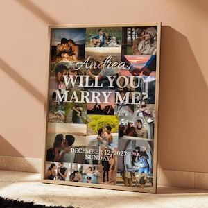 May include: A framed collage with various photographs of couples, and the text "Andrea, WILL YOU MARRY ME?" in white. The date "DECEMBER 12 2027 SUNDAY" is also displayed. The frame is a light wood colour.
