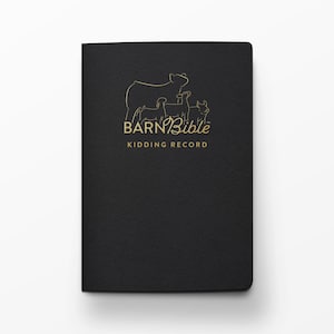 May include: A black notebook with a gold foil outline of a goat and two kids on the cover. The text reads BARN Bible KIDDING RECORD in gold lettering. The notebook has a rectangular shape with rounded corners and a textured matte finish.