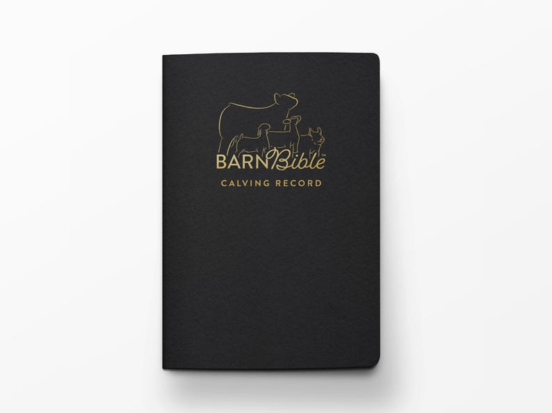 May include: A black notebook with gold lettering and a line drawing of a cow and calves. The text on the cover reads "BARN Bible CALVING RECORD". The notebook is closed and has a textured surface.