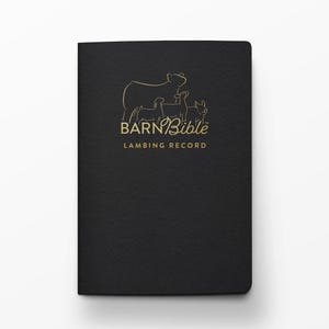 May include: A black notebook with gold lettering and a gold illustration of a cow and lambs. The text on the cover reads "BARN Bible LAMBING RECORD". The notebook has a textured cover.