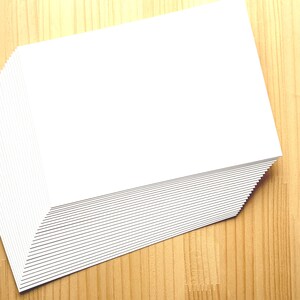 A stack of off white Japanese blank postcards.