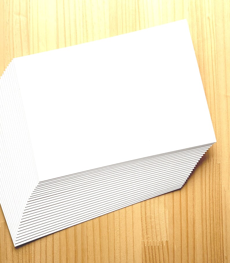 A stack of off white Japanese blank postcards.
