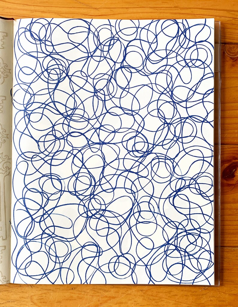 A sample image of pattern designs using hand carved rubber stamps available in the shop. This one shows the repeat pattern of layered doodle lines, stamped in blue.