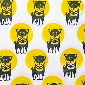 A sample image of pattern design using hand carved rubber stamps available in the shop. Shiba Inu puppies in black and circles in yellow.