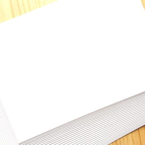 A stack of off white Japanese blank postcards.