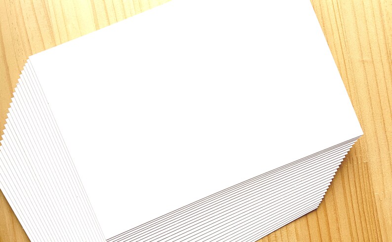 A stack of off white Japanese blank postcards.