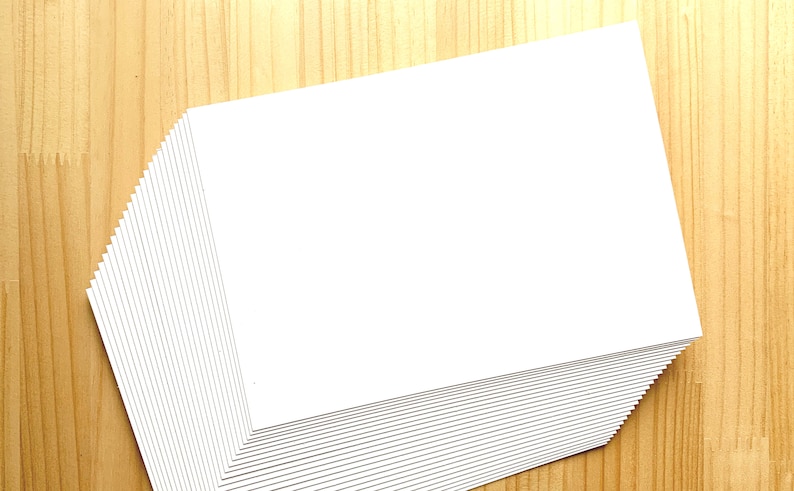 A stack of off white Japanese blank postcards.