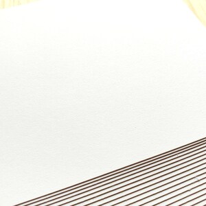 A stack of off white Japanese blank postcards.