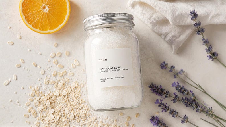 Jar of Rice and Oat bath soak containing pale mineral salts with finely powdered rice and oats.