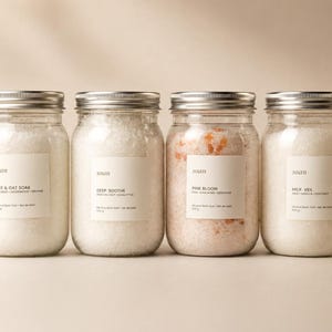 Four Soan mineral bath salt jars arranged together, showing the Forest Steam, Rice and Oat, Deep Soothe, Pink Bloom, and Milk Veil blend options