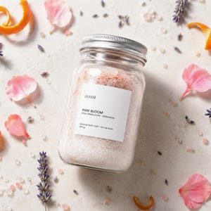 Clear jar of pink mineral bath salts made with pink Himalayan salt and a lavender-geranium fragrance