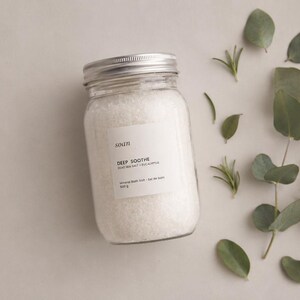 Jar of Deep Soothe mineral bath salts featuring Dead Sea salt and a crisp eucalyptus and camphor aroma.