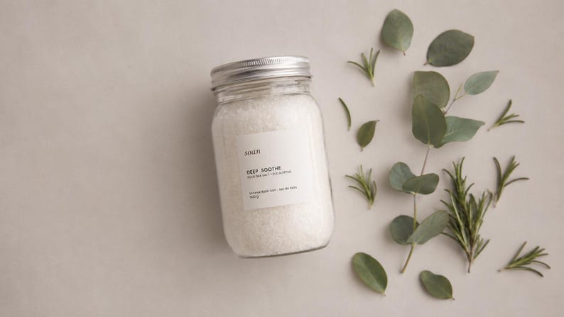 Jar of Deep Soothe mineral bath salts featuring Dead Sea salt and a crisp eucalyptus and camphor aroma.
