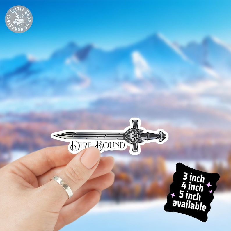 May include: A black and white sticker of a sword with the words "Dire Bound". The sword has a wolf head design on the hilt. Available in 3, 4, and 5 inch sizes.