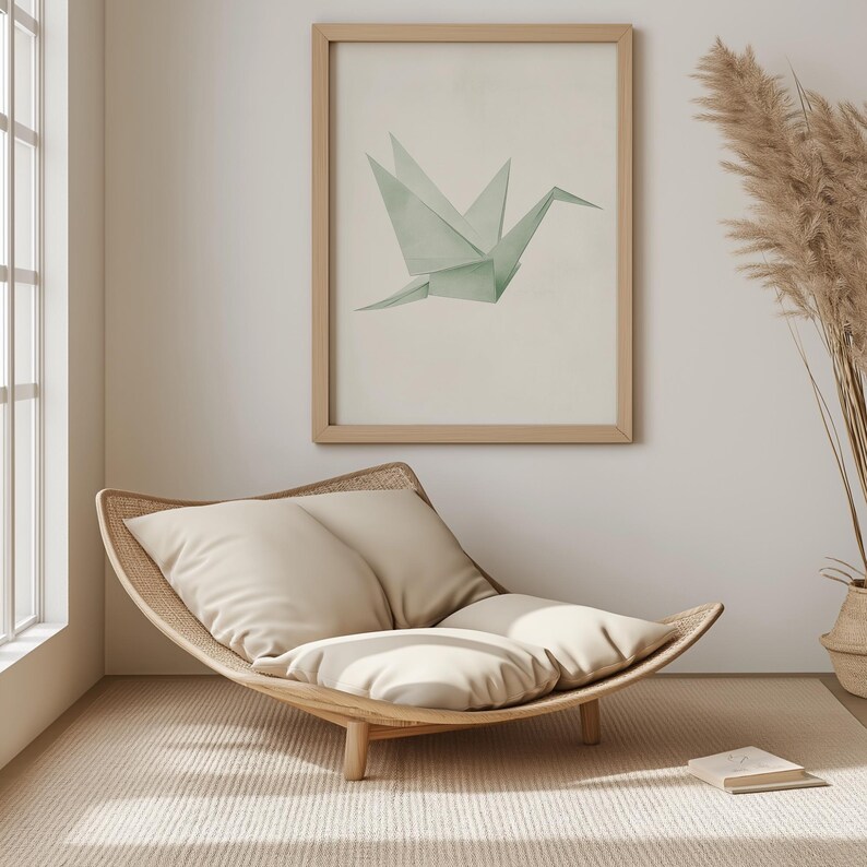 May include: A light wood, crescent-shaped chair with two beige cushions. The chair is in a room with a framed print of a green origami crane and a vase of dried pampas grass.