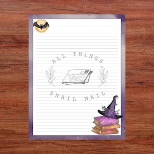 May include: Lined stationery with a purple border, featuring a bat illustration, the text "ALL THINGS SNAIL MAIL", and a witch's hat atop books. The design includes a vintage letter illustration and floral accents.