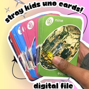 May include: A fan of cards featuring a green card with the number nine and a photo of a group of people. The cards are fanned out, with the text "stray kids uno cards!" and "digital file" on a colorful background.