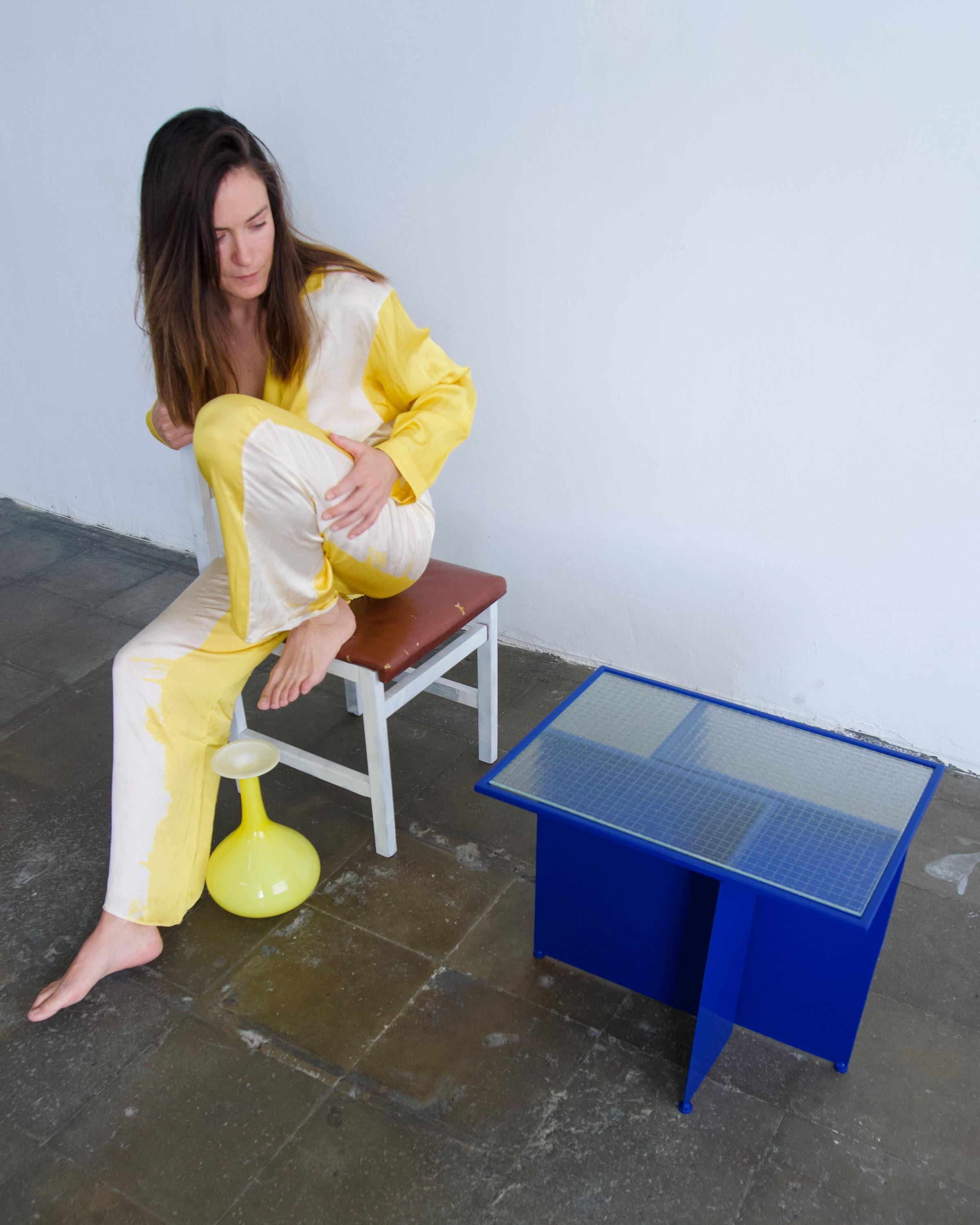 Unique designer table. Iron and glass table with straight shapes.