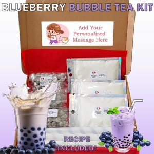May include: A brown cardboard box with a red lid, open to reveal a blueberry bubble tea kit. The kit includes bubble tea powder, tapioca pearls, and a recipe. The box has a personalized message area with a cartoon illustration of a girl drinking bubble tea.