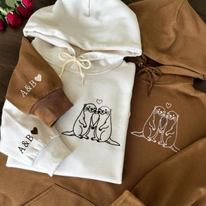 Otter Love Matching Couple Embroidered Hoodie With Personalized Sleeve Initials - Cute Anniversary Sweatshirt Gift For Him And Her