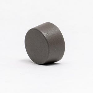 May include: A dark grey ceramic knob with a smooth, rounded surface.