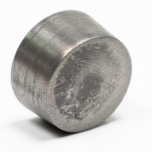 May include: A silver metal cap with a textured surface.