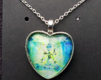Meditating Skeleton Blue Silver Heart Pendant Necklace Cabochon,  Hand embellished Original Artwork by Artist Heather Calderon