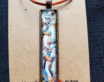 Beach Skeletons  Pendant Cabochon Necklace  Hand embellished Original Artwork  by Artist Heather Calderon