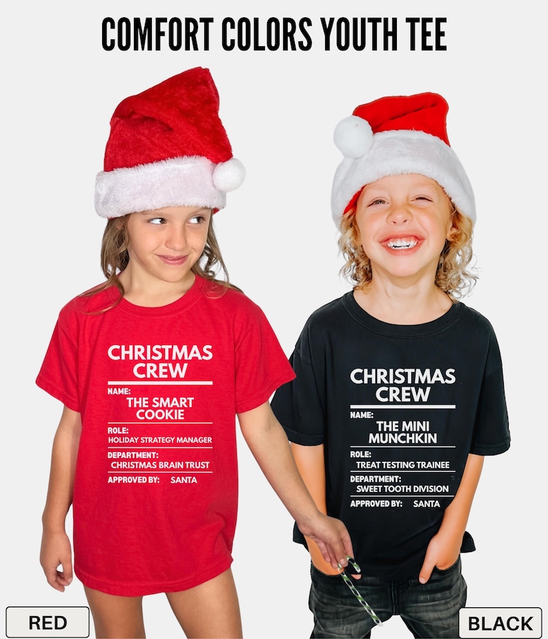 May include: A red t-shirt and a black t-shirt featuring white text that reads COMFORT COLORS YOUTH TEE, CHRISTMAS CREW, NAME: THE SMART COOKIE, ROLE: HOLIDAY STRATEGY MANAGER, DEPARTMENT: CHRISTMAS BRAIN TRUST, APPROVED BY: SANTA, and THE MINI MUNCHKIN.