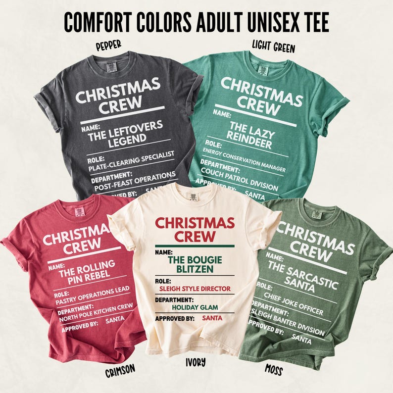 Set of Comfort Colors unisex Christmas T-shirts in festive tones: Pepper, Light Green, Crimson, Ivory, and Moss. Each shirt reads “CHRISTMAS CREW” at the top with a fun holiday badge layout showing “NAME,” “ROLE,” and “DEPARTMENT.” Designs include The Leftovers Legend, The Lazy Reindeer, The Rolling Pin Rebel, The Bougie Blitzen, and The Sarcastic Santa, each with humorous holiday titles and North Pole–themed departments.