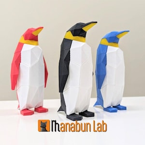 May include: Three 3D printed penguin figurines, each with a different color: red, black, and blue. The penguins are stylized with a geometric design and have yellow beaks and feet.