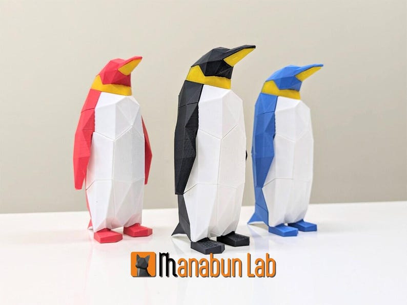 May include: Three 3D printed penguin figurines, each with a different color: red, black, and blue. The penguins are stylized with a geometric design and have yellow beaks and feet.