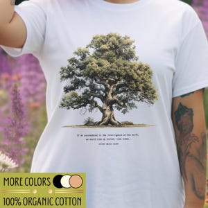 May include: White t-shirt with a detailed tree illustration and the quote: "If we surrendered to the intelligence of the earth, we would rise up rooted, like trees." The shirt is made of 100% organic cotton. The image also shows a colour palette.