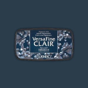 May include: A rectangular VersaFine CLAIR pigment ink pad in the color "Twilight." The ink pad has a dark blue background with a floral design and the brand name and ink type printed in white.