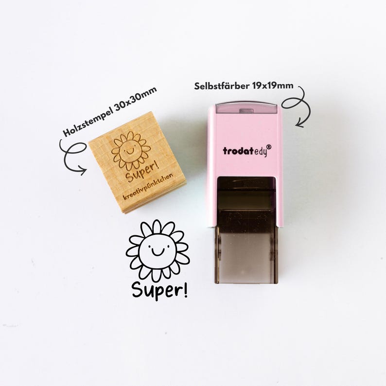 May include: A wooden stamp (30x30mm) and a pink self-inking stamp (19x19mm) with a smiling flower design and the word "Super!". The wooden stamp has the text "kreativp&uuml;nktchen" below the flower.