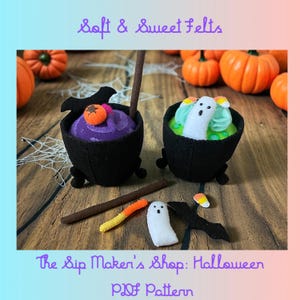 May include: A Halloween-themed felt craft featuring two black cauldron-shaped bowls filled with purple and green felt. The purple cauldron has an orange pumpkin on top. The green cauldron has a white ghost. The text reads "Soft & Sweet Felts" and "The Sip Maker's Shop: Halloween PDF Pattern."