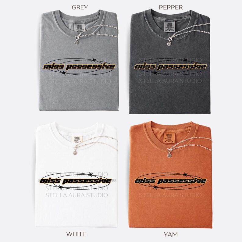May include: Four t-shirts in different colors: grey, dark grey, white, and orange. Each t-shirt has the text 'miss possessive' printed on the front in black with a yellow outline and a circle around the text with black stars.