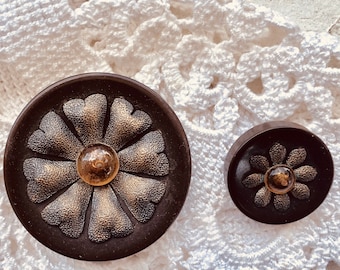 2 Matching brown bakelite buttons - 1 large and 1 smaller - center piece metal and amber glass flower