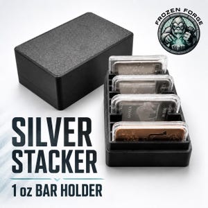 May include: A black plastic storage box and a matching open-top organizer tray holding four rectangular silver bars in clear protective cases. The text "SILVER STACKER 1 oz BAR HOLDER" is printed in black, and a "FROZEN FORGE" logo is visible.