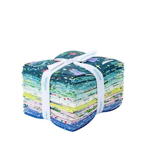 May include: A stack of colorful fabric squares tied with a white ribbon. The fabric features various patterns in shades of blue, green, yellow, and pink. The ribbon has text that reads "Riley Blake Designs".