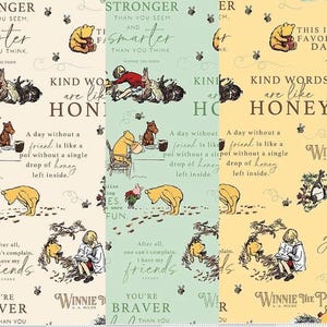May include: Fabric featuring Winnie the Pooh characters and quotes. The design includes illustrations of Pooh, Piglet, Eeyore, and other characters, along with text like "Kind words are like honey." The color palette includes cream, green, and yellow.