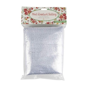 May include: Heat-resistant batting in a clear plastic package. The packaging features a floral design and the text "Heat Resistant Batting" and "1 Yard | 36 x 45". The batting is a light silver color and has a textured surface.