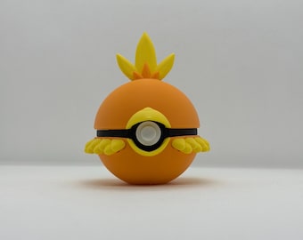 May include: Orange and yellow spherical toy with a black band and yellow accents. The toy has a flame-like design on top and yellow, petal-like shapes around the bottom. The center features a white circle.