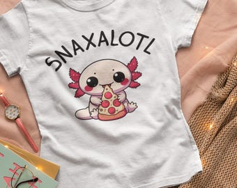 May include: White t-shirt with the text "SNAXALOTL" above a cartoon axolotl eating pizza. The axolotl is light pink with red gills and is holding a pizza slice with red pepperoni. The shirt is on a pink surface.