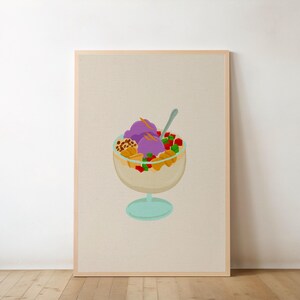 May include: A framed print featuring a colorful illustration of a halo-halo dessert. The dessert is in a clear glass bowl with a light blue base and includes purple ice cream, fruit, and other toppings. The background is a neutral beige.